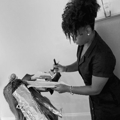 Portrait of Brittney Cowan, a professional stylist at Salon Caru, showcasing their expertise and style.