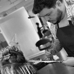 Portrait of Jason Torres, a professional stylist at Salon Caru, showcasing their expertise and style.